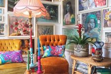 a colorful gallery wall taking two walls, with vintage paintings in neutral frames, with portraits and botanicals is amazing