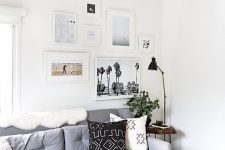 a contemporary gallery wall with a free form and mismatching white frames plus colored and black and white prints and photos