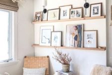 a farmhouse gallery wall with stained wooden ledges, colorful artworks and family makes the space more welcoming and cozy