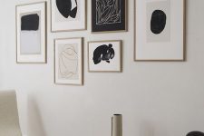 a minimalist gallery wall with a free form and matching stained frames of various sizes is a cool idea for a modern space