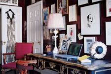 a whimsical vintage home office with black walls, a refined black and gold desk, a leopard print chair and a fuchsia one, a quirky gallery wall