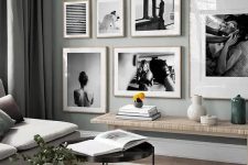 an eye-catchy black and white gallery wall with a free form and light-stained wooden frames for a more interesting look