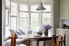 33 a cozy farmhouse dining space with a bow window featuring semi sheer blinds on each part to make the space more private when needed