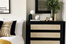 a black dresser with cane drawers is a wonderful contrasting unit used as a nightstand is a very chic solution for a modern bedroom