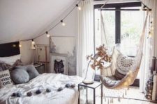 a boho attic teen room with a bed, a suspended chair, lights and lots of artworks is a lovely space to be