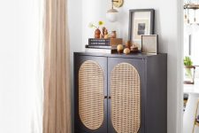 a graphite grey storage unit with doors with can webbing and a drawer plus short legs is a cool and chic idea