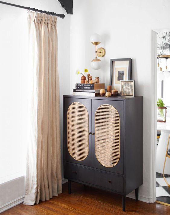 a graphite grey storage unit with doors with can webbing and a drawer plus short legs is a cool and chic idea