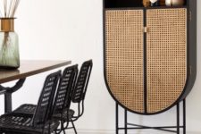 a refined black storage unit with cane doors is a very chic and gorgeous solution for any modern space, can be used as a bar or as a display unit