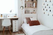 a serene Scandinavian teen bedroom with shelves, a desk, a bed, neutral textiles, a gallery wall with string lights and a fluffy lamp