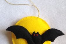 02 a bold Halloween ornament of felt showing a yellow moon and a bat is classics for this holiday and you can DIY it