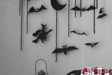 05 a wall hanging with black felt ornaments – half moons, witches, bats and just some twine, these ornaments can be used for Halloween tree decor