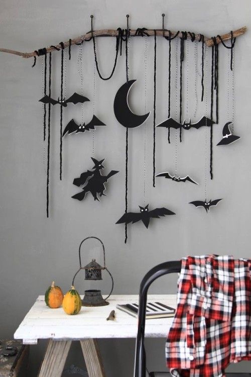 A wall hanging with black felt ornaments   half moons, witches, bats and just some twine, these ornaments can be used for Halloween tree decor