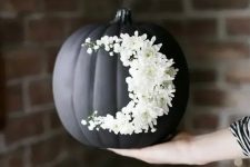 05 go for creative art decorating your matte black pumpkin with white blooms like that – this isn’t a durable decoration but a very cool one