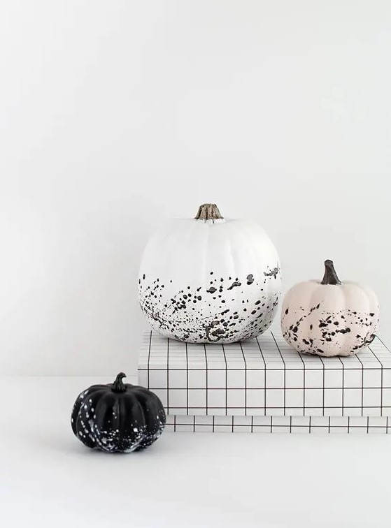 gorgeous modern Halloween pumpkins - a white, black and blush one with splatters are awesome