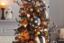 15 a black Halloween tree with white, gold, orange and black and white ornaments, lights, wire and balls is amazing