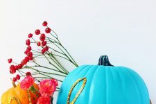 16 a bold blue pumpkin decorated with gold sequins that form a word is a cool and bright idea for Halloween