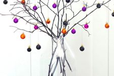 17 a branch Halloween tree with mini black, orange and purple ornaments – just buy some pretty colorful ones and create a tree