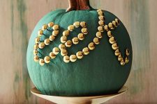 17 a chic matte green pumpkin decorated with gold beads is a chic and stylish decoration for Halloween