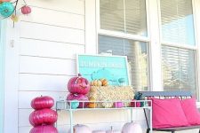 18 a bright and fun Halloween porch with turquoise, pink, blush pumpkins and signs and pillows
