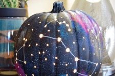 19 a galaxy pumpkin is a trendy idea for those of your who enjoy celestial Halloween decor and want something special