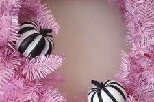 20 a gorgeous faux evergreen Halloween wreath with black and white stipred pumpkins is a perfect idea for your front door