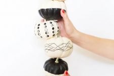 21 modern black and white Halloween pumpkins decorated with paint and a black sharpie are a great idea for a boho party