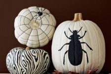 25 white pumpkins decorated with a black sharpie – a spiderweb, a zebra print and a large bug- are a great idea for Halloween