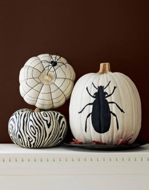 White pumpkins decorated with a black sharpie   a spiderweb, a zebra print and a large bug  are a great idea for Halloween