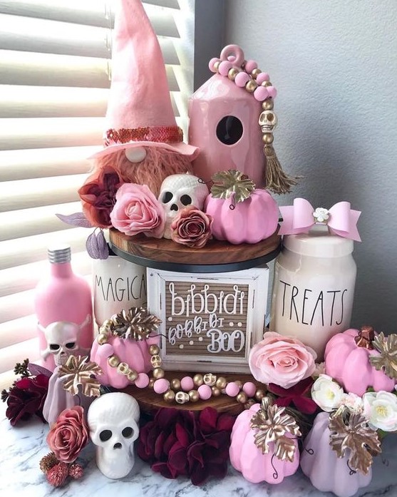 amazing pink Halloween decor with pink pumpkins, bottles, a gnome, some bows, beads and skulls is gorgeous