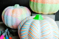 27 white pumpkins made super colorful using colorful sharpies is a great idea for modern and bright Halloween