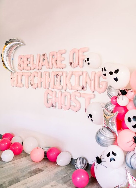 Gorgeous pink Halloween styling with lots of balloons   pink, silver and scary ghost ones, pink balloon letters and a silver moon