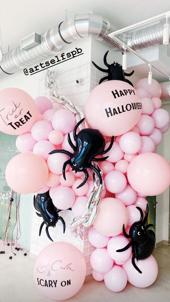 Jaw dropping Halloween decor with pink ballons, oversized black spider balloons, chains is fantastic for a party