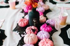 31 super glam Halloween table decor with a black runner, pink, blush, lilac and hot pink pumpkins and bold blooms