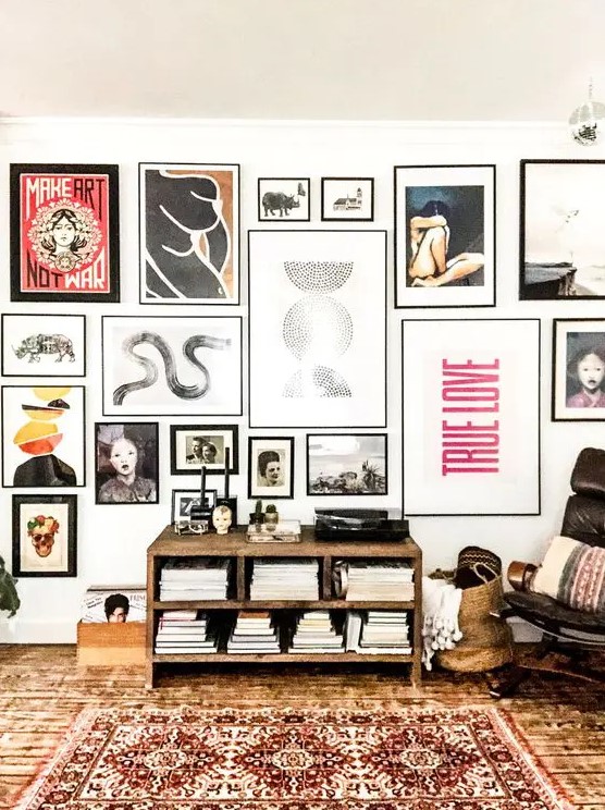 A bold and eye catchy gallery wall with various types of art in mismatching black frames will make a statement anywhere