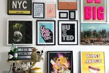 a colorful pop art gallery wall in various colors – posters for fun and with black and white frames is a bold idea