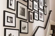 a free form gallery wall with mismatching black frames, black and white photos will refresh the space in a stylish way