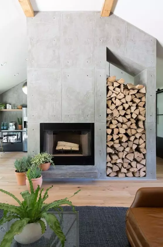 a modern concrete fireplace with an oversized nich for storing firewood is a cool statement for any space