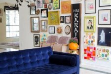 an eclectic and colorful gallery wall with bold paintings, posters, signs, prints and various elements to make it catchier
