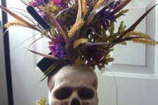 06 a skull vase with bold blooms, grasses and bright faux flowers is a lovely idea for Halloween, it can be used as a centerpiece