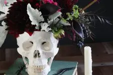 08 a skull vase with dark dahlias, callas, greenery, berries and some dark foliage is a stunning Halloween centerpiece