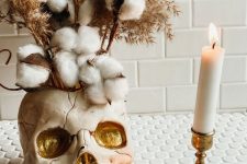 09 delicate Halloween decor with a neutral and gold skull vase, cotton branches, grasses and candles is a gorgeous idea