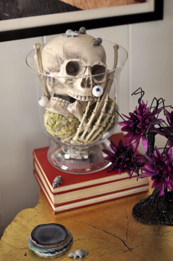 A clear bowl with a skull, skeleton hands, eyeballs and mice is a very easy last minute Halloween decoration or centerpiece
