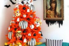 11 a gradient orange, yellow and white Halloween tree decorated with ghosts, striped ornaments, masks and bats