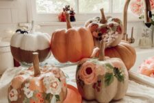 11 earthy-toned painted floral pumpkins are a pretty solution for a rustic or boho fall or Halloween space
