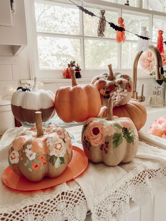 Earthy toned painted floral pumpkins are a pretty solution for a rustic or boho fall or Halloween space