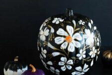 12 elegant Halloween pumpkins – a black one with gorgeous white blooms painted, a black and white and a purple one