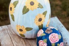 13 light blue and navy pumpkins with bold painted blooms are amazing for your fall decor, both indoor and outdoor