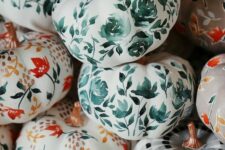 18 white pumpkins painted with bold red blooms and branches, green blooms and leaves and plaid pattern are amazing for the fall