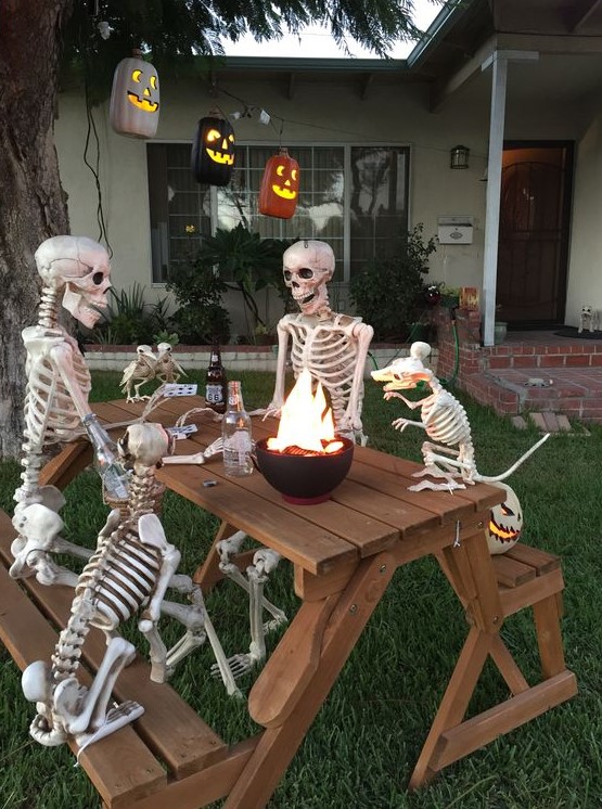 A cool outdoor bbq scene done with skeletons and skeleton dogs plus jack o lanterns is a very fresh and fun idea
