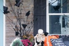 20 a cozy rustic Halloween scene with a skeleton petting its skeleton dog, blackbirds and jack-o-lanterns is lovely